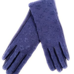 May include: A pair of navy blue gloves with a floral pattern. The gloves are made of a soft material and are designed to keep hands warm. The gloves are shown on a white background.