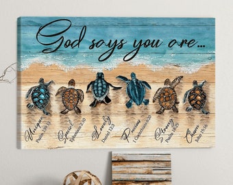 May include: A wooden canvas print with a blue and white ocean scene. The text "God says you are..." is written in black cursive. Seven sea turtles are walking on the beach with bible verses written below each turtle. The verses are: Unique - Psalm 139:13, Special - Ephesians 2:10, Lovely - Daniel 12:3, Precious - 1 Corinthians 6:20, Strong - Psalm 18:25, Chosen - John 15:16.