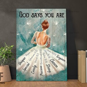 May include: A teal and white canvas print with a woman in a white dress with the words "God Says You Are" at the top. The dress has bible verses and words like "Unique", "Special", "Lovely", "Precious", "Strong", "Chosen", and "Forgiven" written on it.