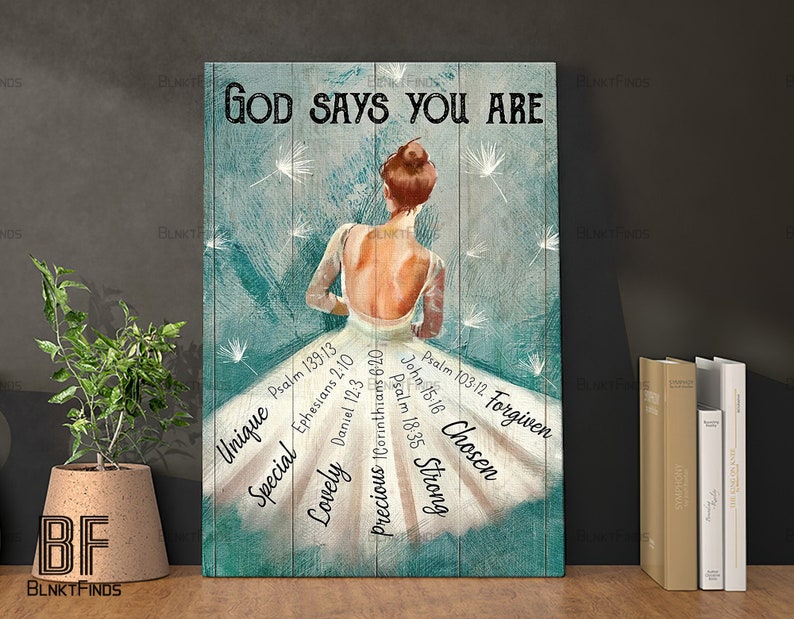 May include: A teal and white canvas print with a woman in a white dress with the words "God Says You Are" at the top. The dress has bible verses and words like "Unique", "Special", "Lovely", "Precious", "Strong", "Chosen", and "Forgiven" written on it.