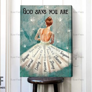 May include: A teal blue canvas print with a white silhouette of a ballerina with a quote "God says you are" and bible verses surrounding the ballerina. The verses include: Psalm 139:13, Ephesians 2:10, Daniel 12:3, 1 Corinthians 6:20, Psalm 103:12, John 15:16, Psalm 18:35.