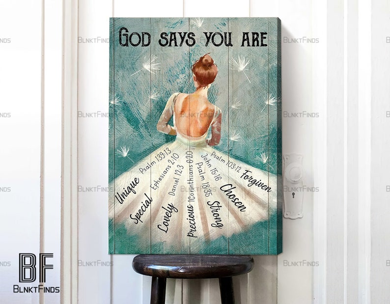 May include: A teal blue canvas print with a white silhouette of a ballerina with a quote "God says you are" and bible verses surrounding the ballerina. The verses include: Psalm 139:13, Ephesians 2:10, Daniel 12:3, 1 Corinthians 6:20, Psalm 103:12, John 15:16, Psalm 18:35.