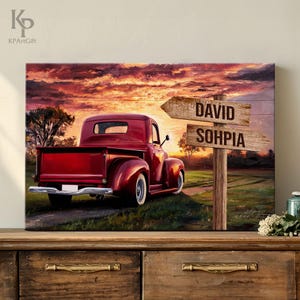 May include: A red vintage pickup truck drives down a country road at sunset. Two wooden signs point in opposite directions, one reading "DAVID" and the other "SOPHIA".