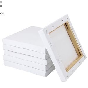 May include: A stack of five white canvas panels with wooden frames. The panels are all the same size and are stacked on top of each other. The top panel is slightly angled to the right.