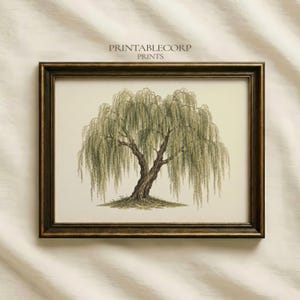 May include: A framed wall art print featuring a detailed illustration of a weeping willow tree with cascading green branches and a textured trunk. The text PRINTABLECORP PRINTS is centered above the tree. The frame is dark brown with gold trim.