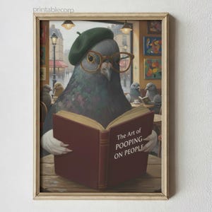 May include: A framed art print featuring a pigeon wearing a beret and glasses, reading a book titled "The Art of Pooping on People." The artwork has a vintage, painterly style, with a cafe setting and other pigeons in the background.