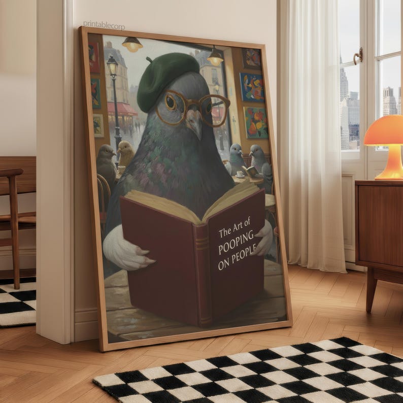 May include: A framed art print featuring a pigeon wearing a beret and glasses, reading a book titled "The Art of Pooping on People." The artwork has a humorous theme, with other pigeons in the background.