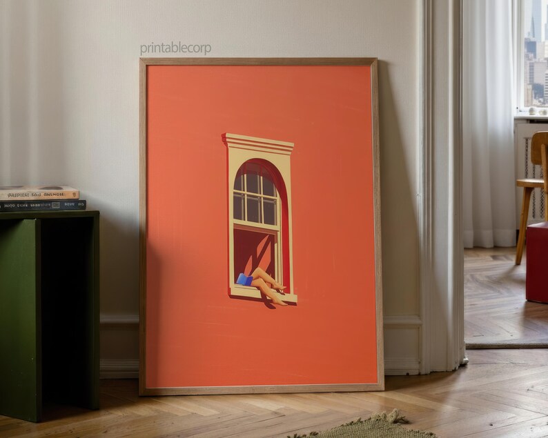 May include: A framed art print featuring a stylized illustration of a window on a coral-colored wall. The window has a white arched top and a person's legs are visible, with blue shorts. The print is displayed on a wooden floor.