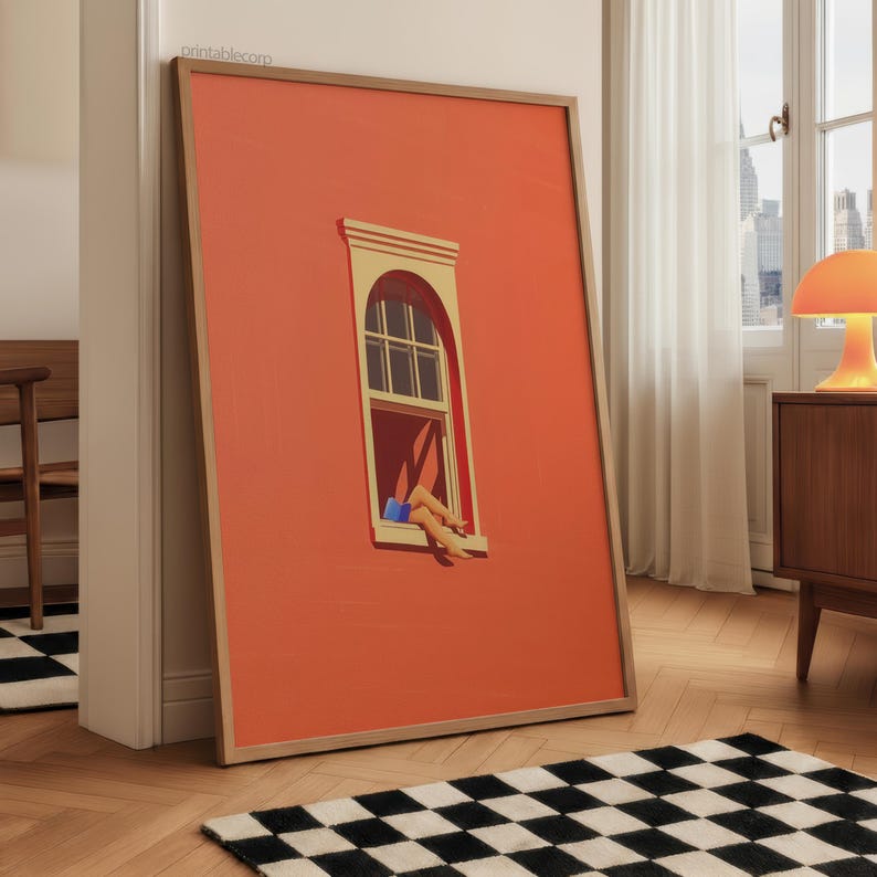 May include: A framed art print featuring a vibrant orange wall with a window. The window depicts legs and a book. The artwork is in a wooden frame and leans against a wall. The floor has a black and white checkered rug.