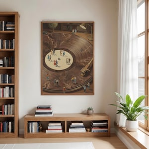 May include: A framed print depicts a vintage record player with miniature figures dancing on the record's surface. The artwork features a warm color palette of browns and tans, with a wooden frame. A lamp and globe are visible in the background.