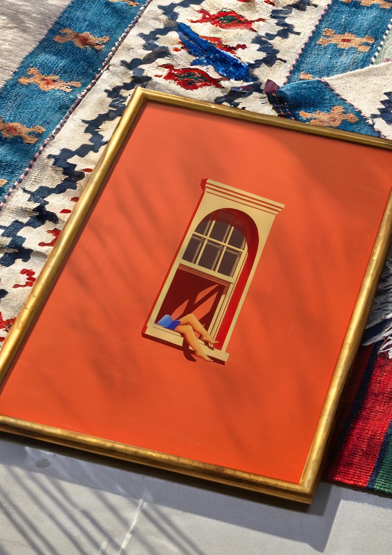 May include: Framed art print featuring an orange background with a gold frame. The artwork depicts a window with a person's legs and feet hanging out. The window is beige and the legs are tan with blue shorts. The artwork is on a colorful rug.