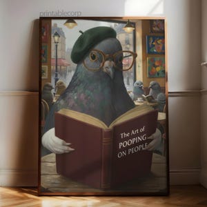 May include: A framed print featuring a pigeon wearing a beret and glasses, reading a book titled "The Art of Pooping on People." The artwork has a humorous theme, set in a cafe with other pigeons.