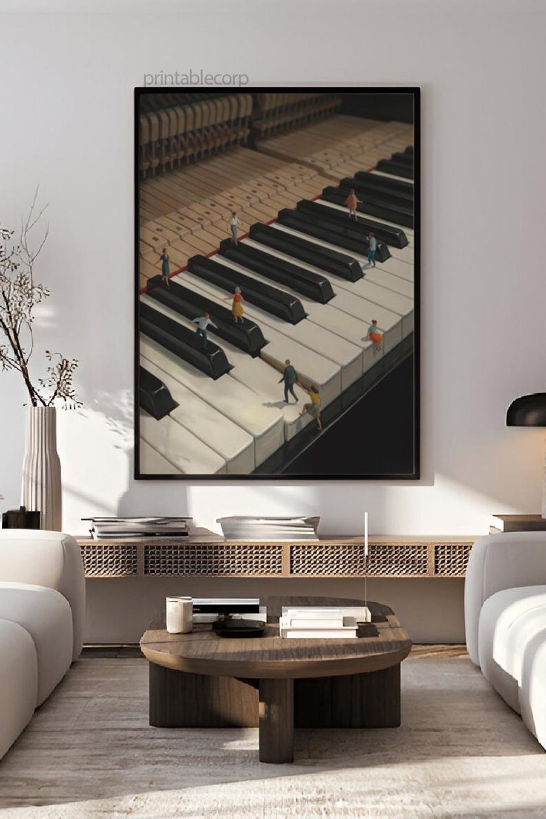 May include: Framed art print featuring a surreal image of a piano keyboard with miniature figures walking on the keys. The artwork has a black frame and is displayed in a modern living room setting. The text "printablecorp" is visible in the top left corner.