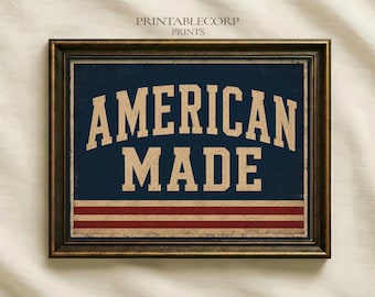 Pode incluir: Uma impressão de arte de parede retangular numa moldura castanho-escura com um fundo azul-marinho e o texto AMERICAN MADE em letras grandes de estilo bloco bege. Abaixo do texto, existem três faixas vermelhas horizontais numa base bege.