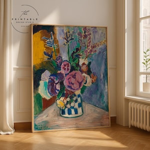 May include: A framed floral still life painting featuring a vase with a blue and white checkered pattern. The bouquet includes pink, purple, and yellow flowers. The background has yellow, blue, and purple hues. The painting is signed "Henri Matisse".