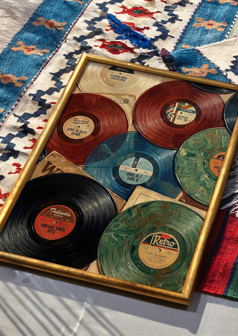 May include: A framed collection of vintage vinyl records. The records are in various colors, including red, blue, green, and black, with labels featuring text like "Soul & Jazz Gems" and "Vintage Vinyl Hits." The frame is gold-colored.