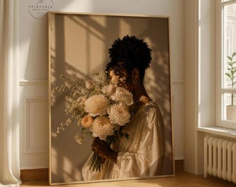 May include: A framed art print featuring a woman holding a bouquet of cream-colored flowers. The woman is wearing a white dress. The print has a neutral color palette with soft lighting, creating a warm and inviting aesthetic. The print is suitable for home decor.