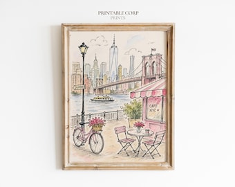 Könnte beinhalten: Eine gerahmte Aquarellillustration einer New Yorker Straßenszene mit einem rosa Fahrrad mit Blumenkorb, einem Café mit gestreifter Markise und der Aufschrift CAFE NYC, einer Straßenlaterne mit DUMBO-Schild und der Brooklyn Bridge im Hintergrund.