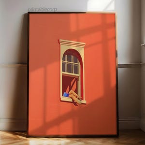 May include: A framed art print featuring a vibrant orange wall with a window. The window is arched and has a white frame. The artwork depicts legs and a blue object inside the window. The text "printablecorp" is in the top left corner.