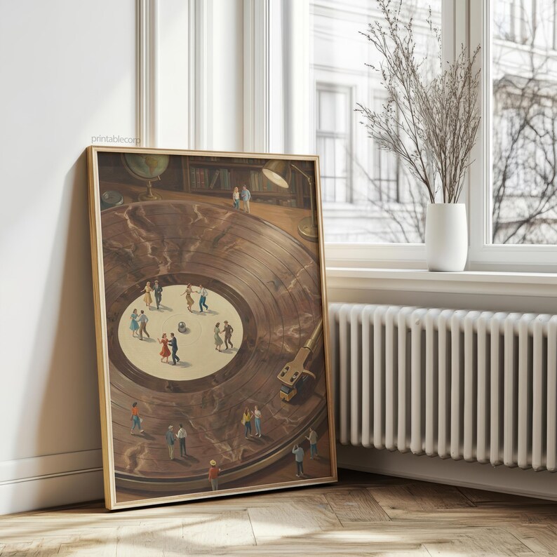 May include: A framed print depicts a vintage record player with miniature figures dancing on the record's surface. The artwork features a warm color palette with a wooden frame, creating a nostalgic and whimsical scene. The print is displayed near a window.