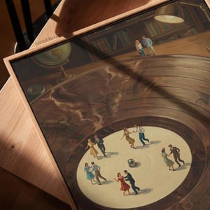 May include: A framed print featuring a vintage-style illustration of couples dancing on a record. The artwork has a warm color palette with a globe and a lamp in the background. The text "printable.com" is visible on the frame.