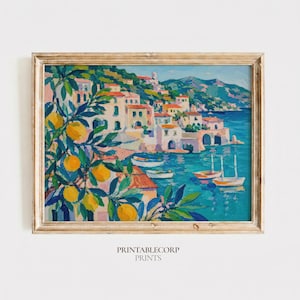 May include: A framed landscape painting depicting a coastal village with white buildings, red roofs, and a blue sea. In the foreground, a tree with green leaves and yellow citrus fruits hangs over the water. Small white boats float on the sea.