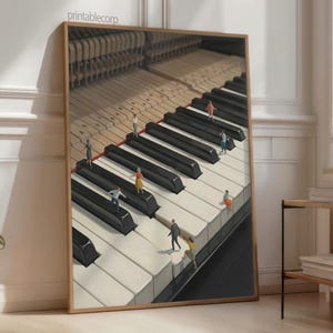 May include: A framed art print depicts a piano keyboard with miniature figures walking on the keys. The keys are black and white, and the frame is a light brown color. The print is leaning against a wall.