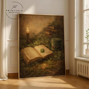 May include: A framed print featuring a vintage illustration with a St. Patrick's Day theme. The artwork depicts an open book with a four-leaf clover, a green top hat, a lit candle, and a stack of books, all set in a field of clovers.