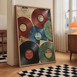 May include: A framed print featuring a collection of vintage vinyl records in various colors, including red, blue, and green. The records are arranged in a collage-like composition, with some partially visible. The print has a wooden frame and is displayed indoors.