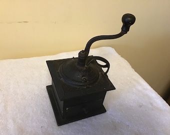 Antique cast iron and wood hand cranked coffee grinder from the 1900s