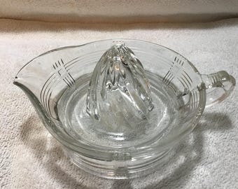 Vintage criss cross pattern glass juice squeezer with a swirled creamer corn.