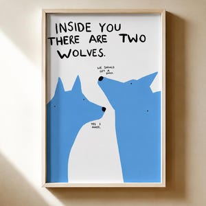 May include: A framed wall art print featuring two blue wolf silhouettes on a white background. The text reads: INSIDE YOU THERE ARE TWO WOLVES. One wolf says: WE SHOULD GET A SHACK. The other wolf replies: YES I AGREE. The frame is light wood.