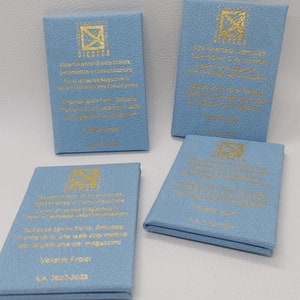 May include: Four blue square cards with gold lettering. The cards have the logo of the University of Bicocca, the department of computer science, and the text "Dipartimento di Informatica, Sistemistica e Comunicazione Corso di Laurea Magistrale in Tecniche e Tecnologie delle Comunicazioni  Rubrica Spreco Ford, Sviluppo frontend di app web e app mobile per la gestione del magazzino  Valeria Froio A.A. 2022-2023"
