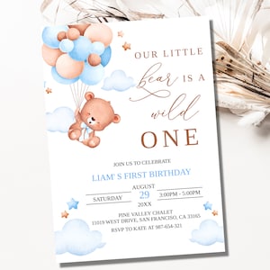 May include: A light blue and brown invitation with a cartoon bear holding balloons. The invitation says "Our little bear is a wild one" and includes details for Liam's first birthday party.