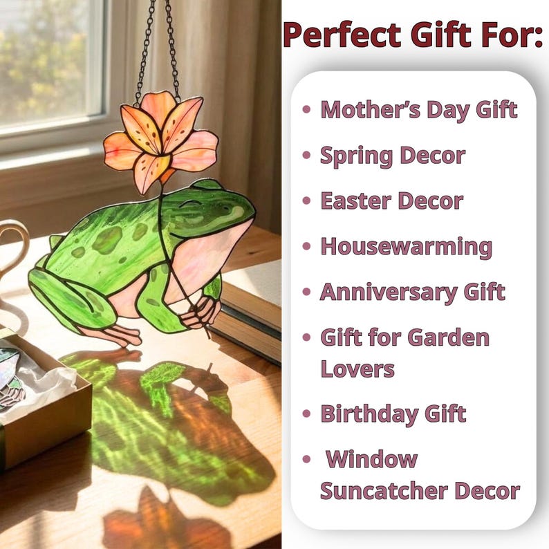 May include: A stained glass frog suncatcher with a flower, hanging from a chain. The frog is green with pink accents, and the flower is orange. The text reads "Perfect Gift For: Mother's Day Gift, Spring Decor, Easter Decor, Housewarming, Anniversary Gift, Gift for Garden Lovers, Birthday Gift, Window Suncatcher Decor."