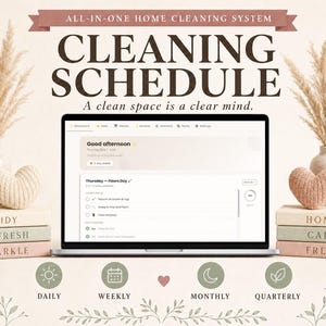 May include: A laptop displays a cleaning schedule interface, with text reading "Cleaning Schedule" and "A clean space is a clear mind." Decorative elements include pampas grass in vases, stacked books, and heart-shaped ornaments. The image promotes home organization.