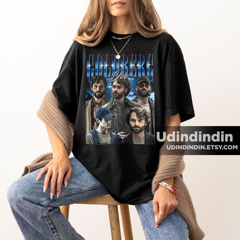 Puede incluir: Camiseta negra con un gr&aacute;fico de estilo vintage del elenco del programa de televisi&oacute;n "The Goldbergs" con el texto "Goldberg Joe" impreso en ella.