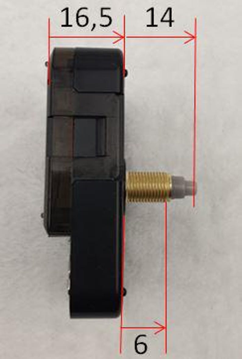 May include: A black clock movement with a gold-colored threaded shaft. The movement measures 6 cm wide, 16.5 cm long, and 14 cm high. The clock mechanism is designed for DIY clock projects.