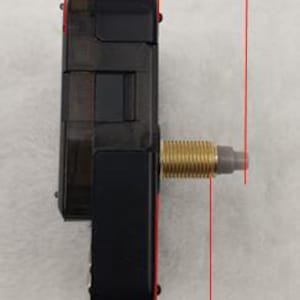 May include: A black clock movement with a gold-colored threaded rod. The movement measures 16.5 mm wide, 18 mm long, and 11 mm high.