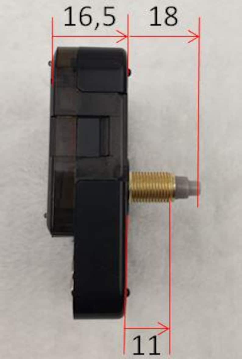 May include: A black clock movement with a gold-colored threaded rod. The movement measures 16.5 mm wide, 18 mm long, and 11 mm high.