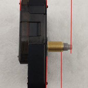 May include: A black clock movement with a gold-colored threaded shaft. The movement measures 16.5 mm wide, 28 mm long, and 18 mm high. The clock movement is designed for use in clocks and other timekeeping devices.