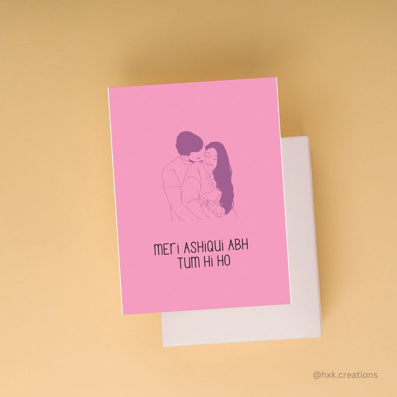 May include: A pink card with a line drawing of a couple embracing. The text on the card reads "Meri Ashiqui Abh Tum Hi Ho".