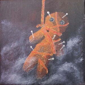 May include: A brown voodoo doll with red string and white pins is hanging from a rope against a dark background with white clouds.