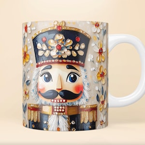 May include: White ceramic mug featuring a colourful illustration of a nutcracker with a blue hat and gold trim. The background is decorated with a floral pattern in shades of yellow, red, and white.