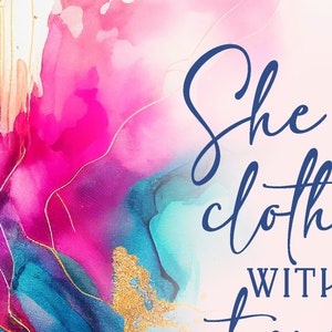 May include: Abstract art print with vibrant hues of pink, teal, and gold. The artwork features fluid ink designs with the words "She is clothed with" in elegant blue script. The background is a soft, off-white color.