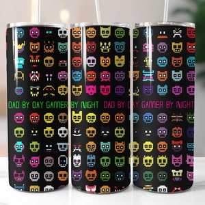 May include: Three stainless steel tumblers with a black background and colorful pixelated faces. The tumblers have the text "Dad by Day Gamer by Night" printed on them.