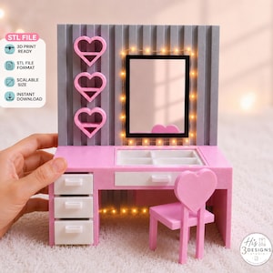 May include: A miniature vanity set featuring a pink desk with three white drawers, a white divided top compartment, and a matching pink chair with a heart-shaped backrest. A gray slatted wall panel holds three pink heart shelves and a lighted mirror.