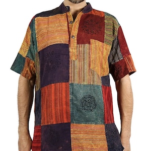May include: A multi-coloured patchwork short-sleeved shirt with a mandarin collar and button-down front. The shirt features a mix of striped and patterned fabric patches in shades of orange, green, red, and purple.