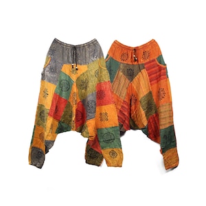 May include: Two pairs of colourful patchwork trousers with a drawstring waist and black printed designs. The trousers are made of a soft, comfortable fabric and have a loose, flowing fit.