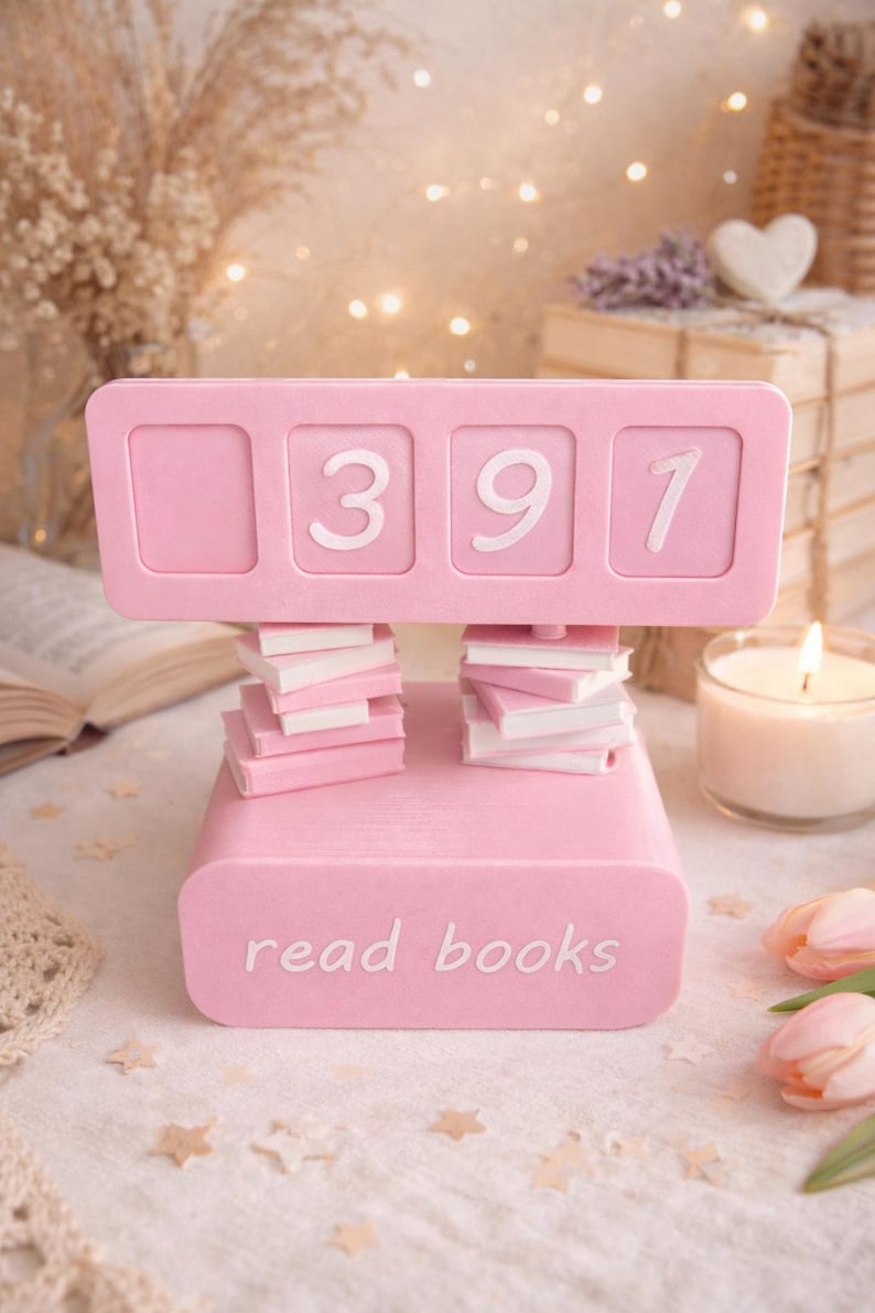 May include: A pink book counter with the numbers 391 displayed. The counter is supported by stacks of miniature books. The base of the counter reads "read books". The image has a soft, romantic aesthetic.
